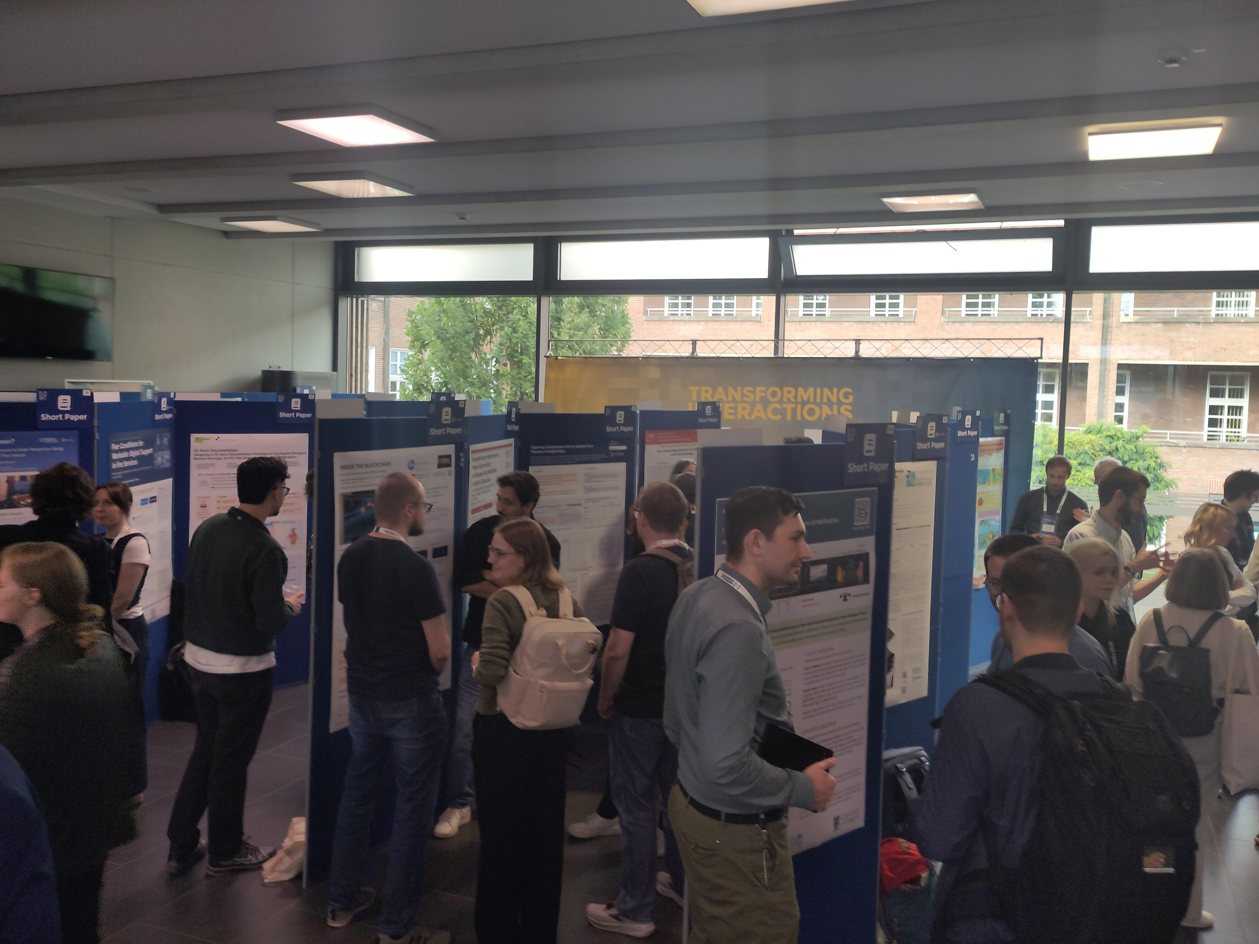 Attendees discussing research posters during the Short Paper session at Mensch und Computer 2026 in Duisburg
